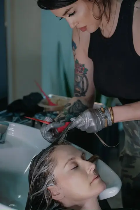 Behind the scenes — Rachel Charles applying color treatment at her Phoenix studio.
